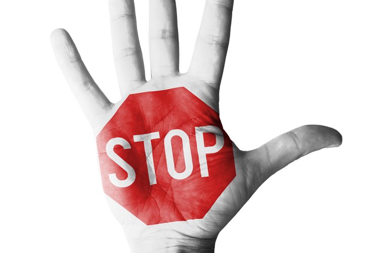 A picture of a hand with the words "stop" written over the palm